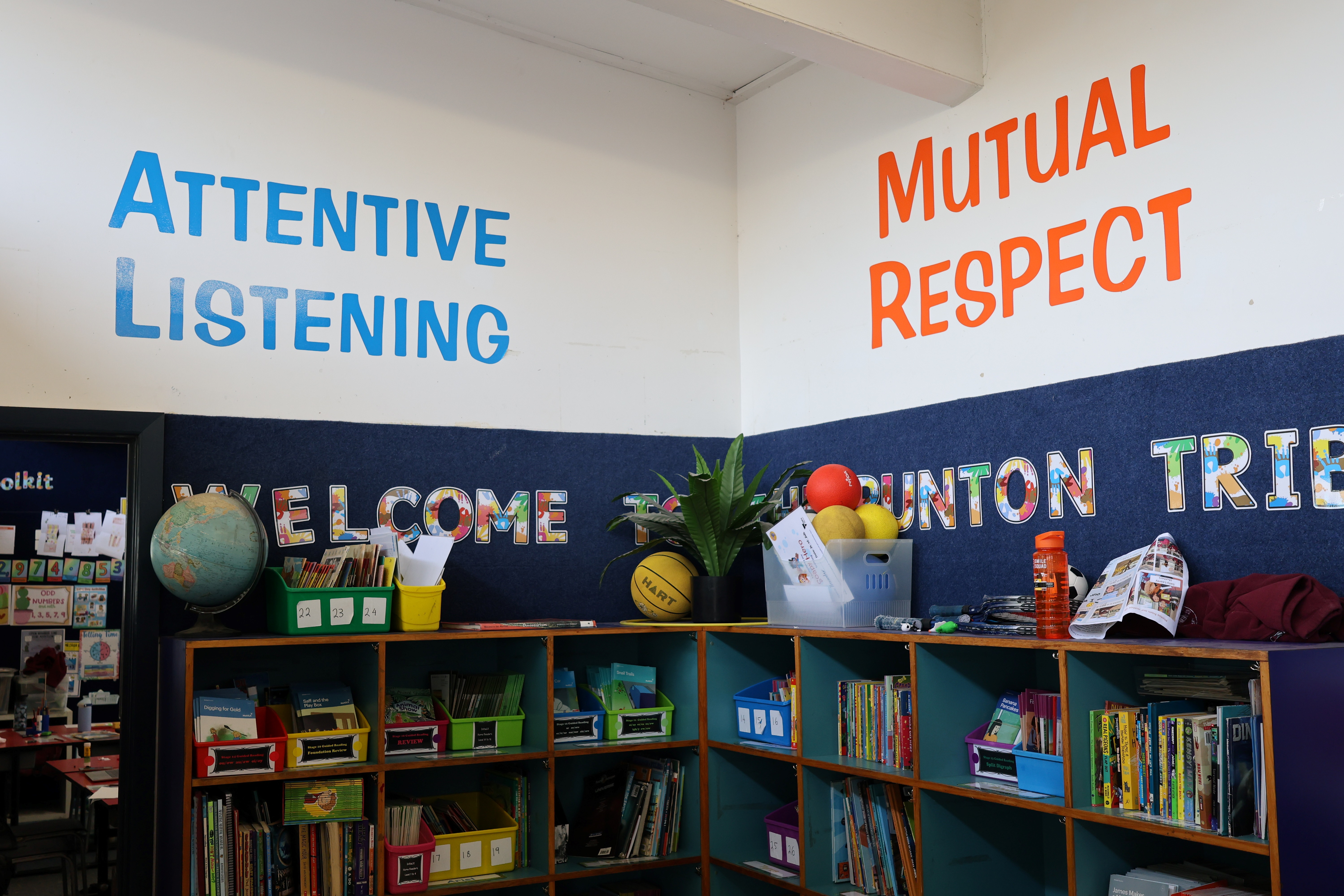 Shelves with attentive listening and mutual respect printed on the wall